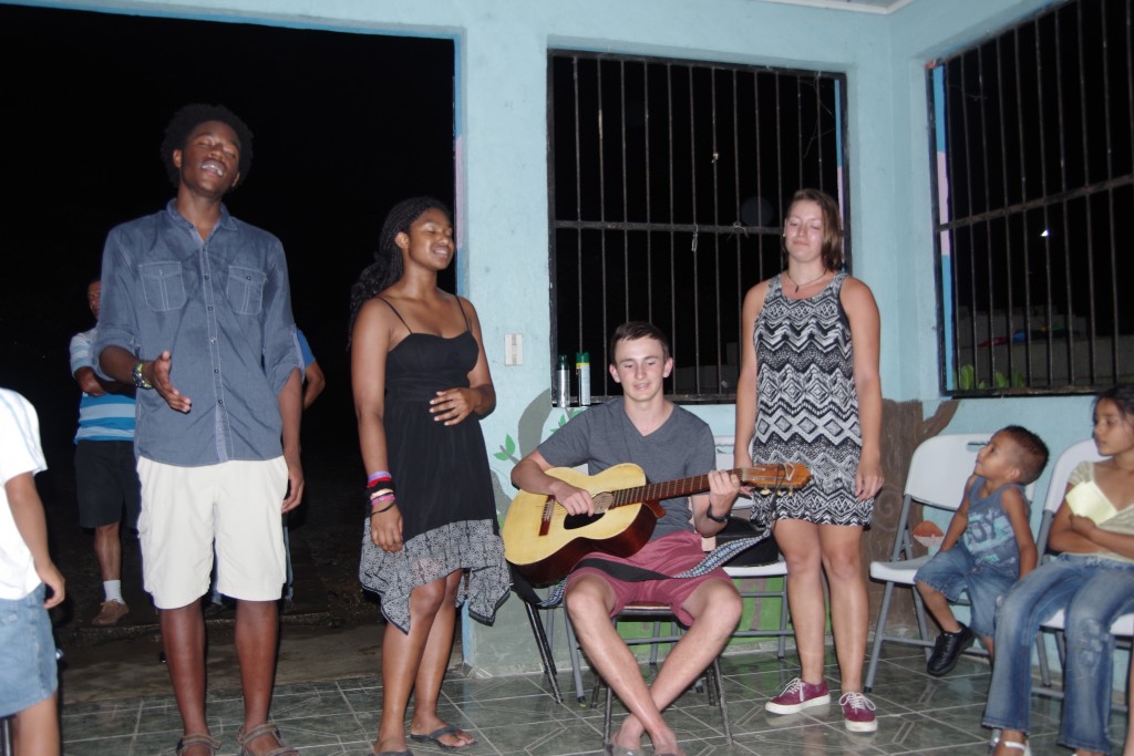 Myles, Taylor, Ned, and Emma singing for the community